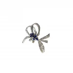 Angled View "An angled shot of the Cropp & Farr brooch, capturing the sparkling sapphires and diamonds, and the graceful curves of the bow design. Stock number: BRQ00050."