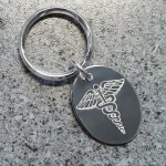 Medic Alert Tag on a key fob in solid silver on granite background.