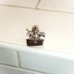 fairy tail pill box in solid silver sitting on a wall.