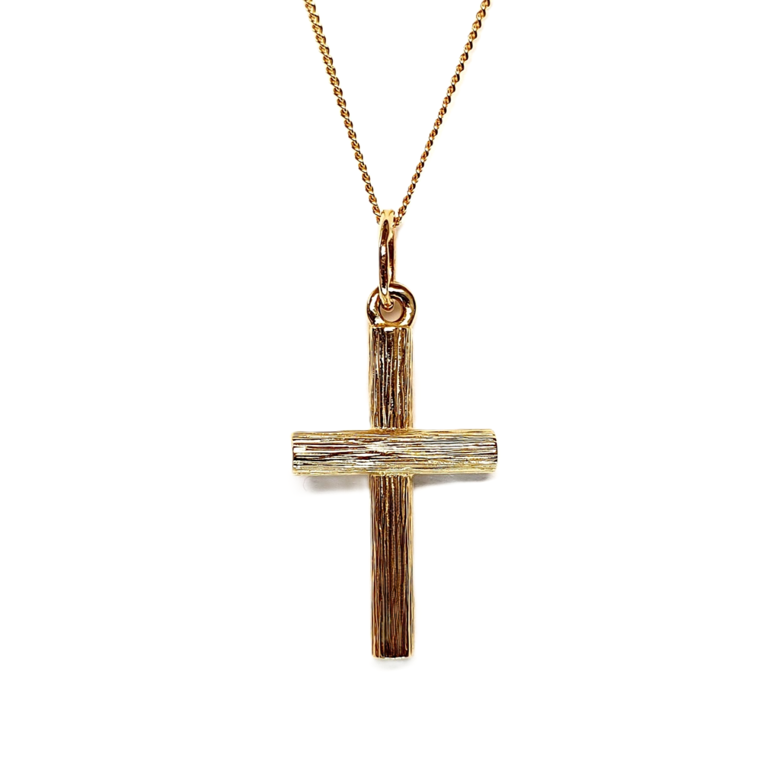 9ct gold cross pendant with hand-engraved tree bark texture.