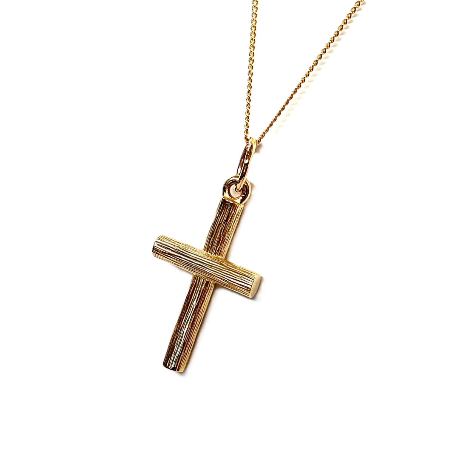 Positioned at a gentle leftward angle against a white background, this shot captures the cross pendant’s depth and texture in a sleek, modern presentation.