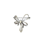 The back view of a bow-shaped brooch highlighting the secure pin and catch mechanism.