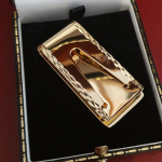 The Threadneedle Street vintage folding paper clip in gold is pictured in an antique-style gift box showing the back.