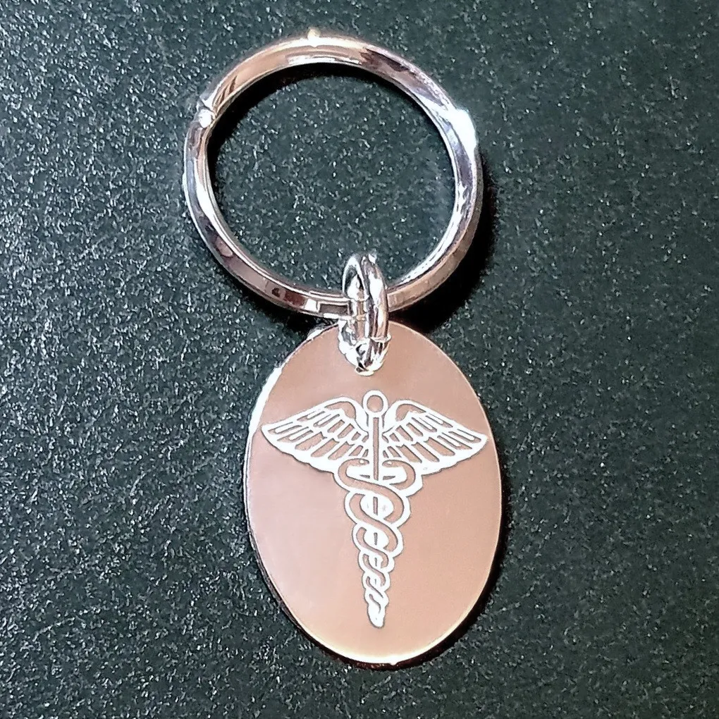 Emergency Medical ID tag for keys in sterling silver on a green leather background.