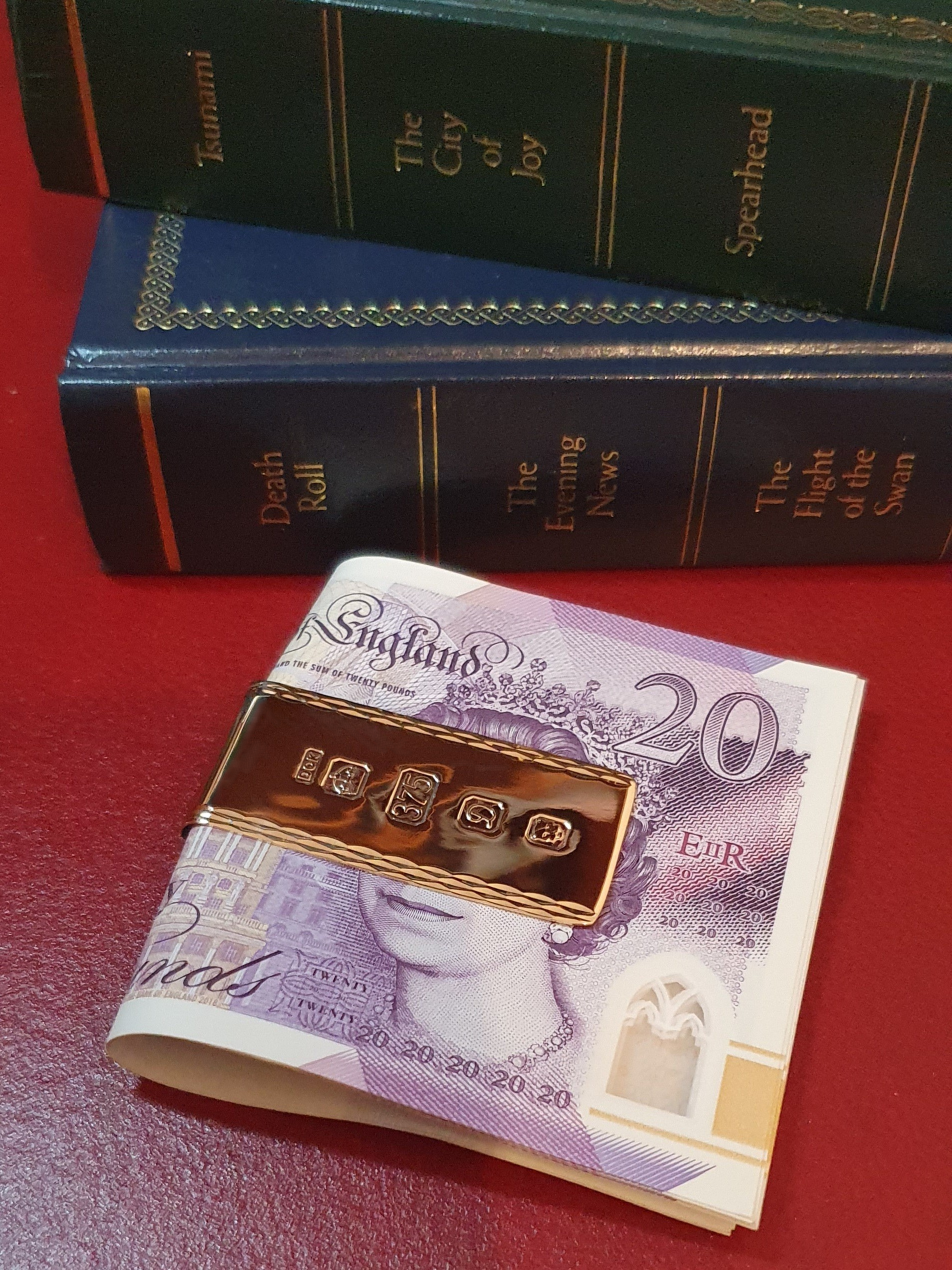 A luxurious hallmarked money holder is pictured with twenty-pound notes.