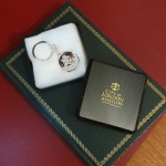 In a plastic and cotton wool box: "Silver Saint Christopher keyring presented in a plastic and cotton wool box with the City of London logo embossed in gold leaf on top."