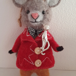 Feline sterling brooch pictured on a toy mouse.