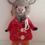 Feline sterling brooch pictured on a toy mouse.