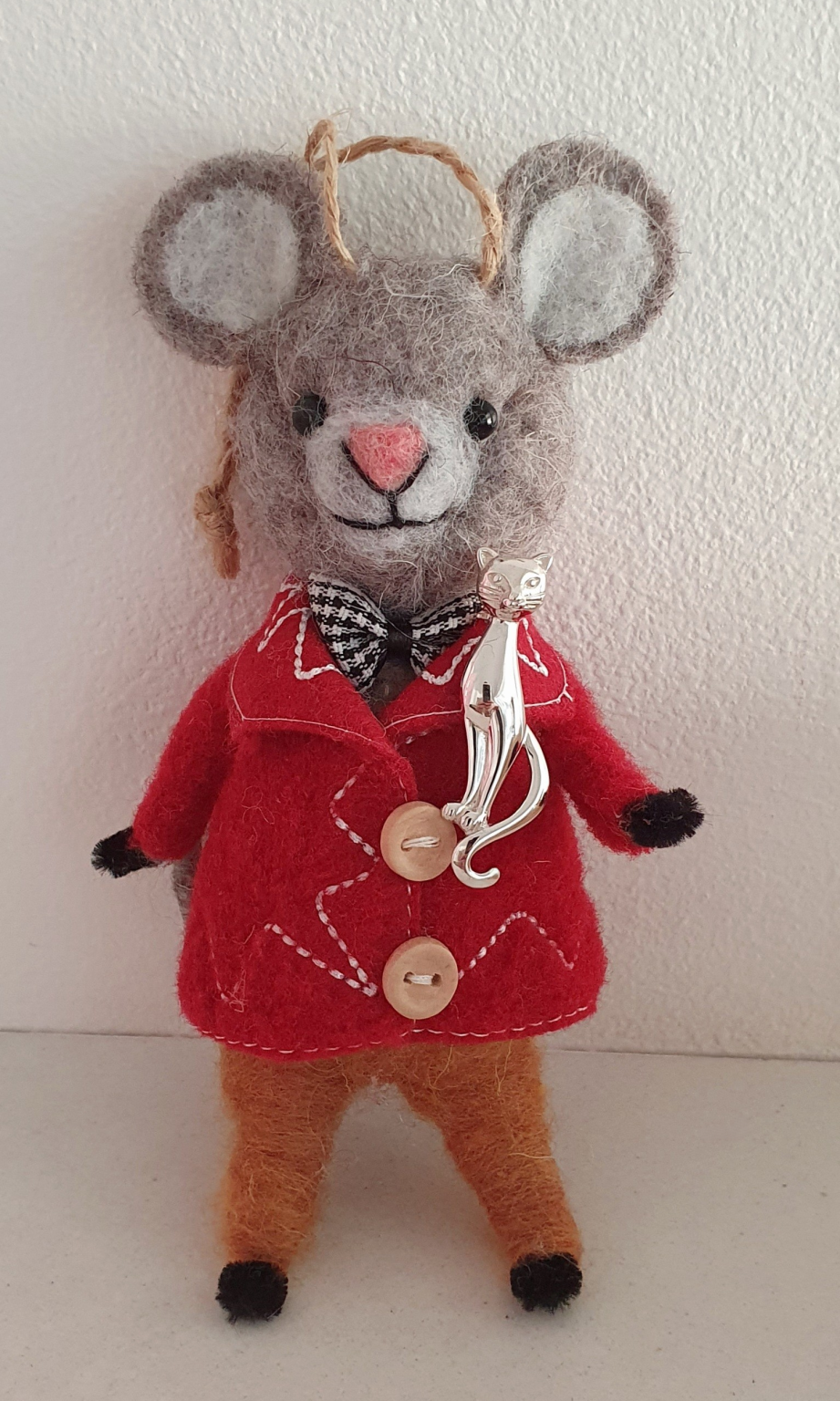 Feline sterling brooch pictured on a toy mouse.