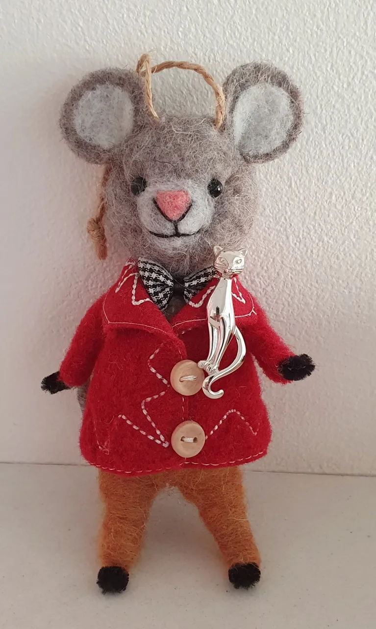Feline sterling brooch pictured on a toy mouse.