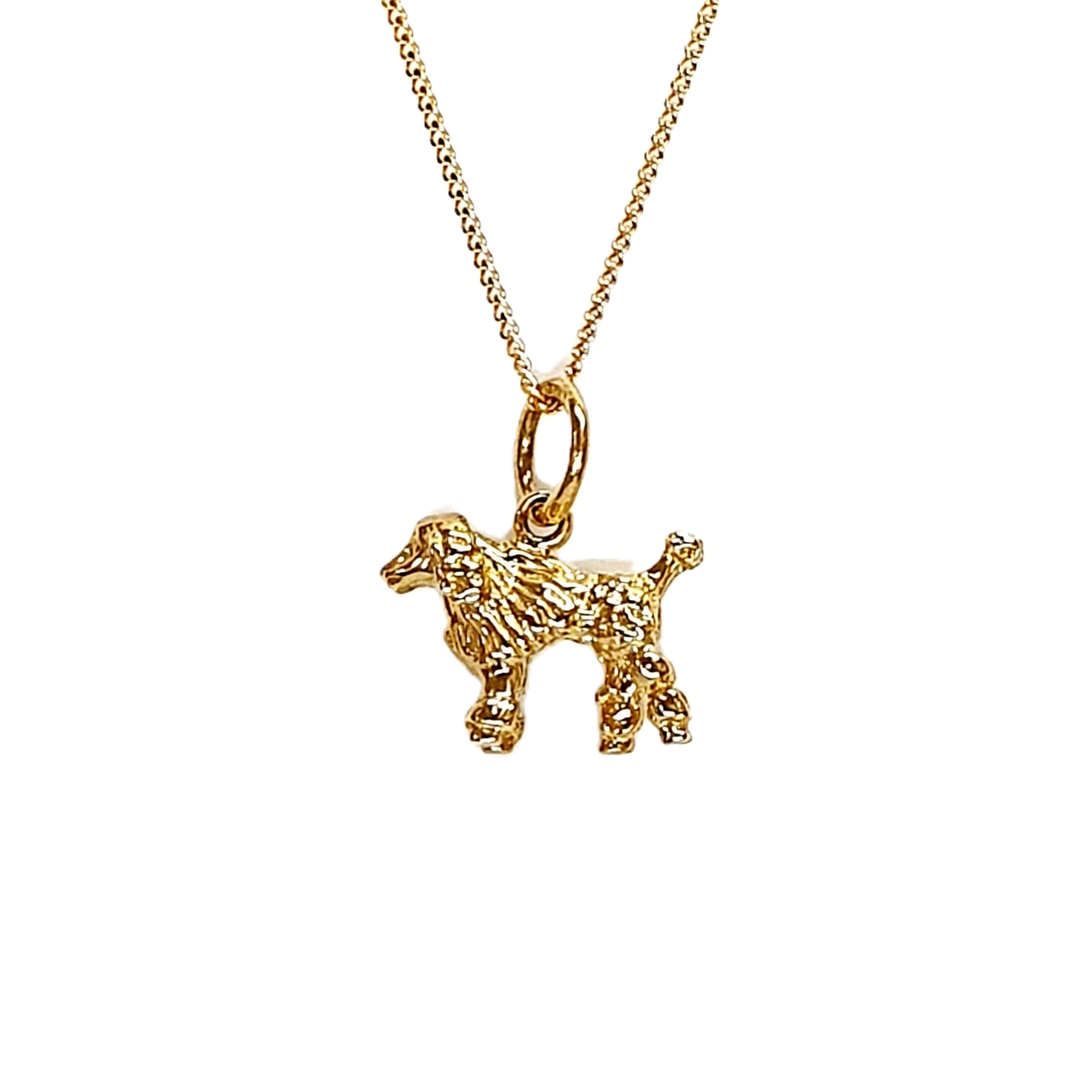 A solid 3D 9ct gold Poodle pendant necklace CMP00299.Pictured close up facing to the left, hanging on a chain.