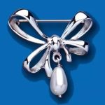 A graceful bow-shaped brooch against a vibrant blue background showcases its intricate design. This 925 genuine sterling silver bow brooch features four delicate loops and two ends.