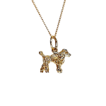 A solid 3D 9ct gold Poodle pendant necklace CMP00299.Pictured close up facing to the right, hanging on a chain.