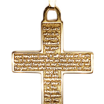 Real gold cross with the Lord's Prayer written on the front. Close up picture.