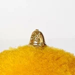 Gleaming gold accessory with a policemen's hat on a cheerful yellow background.