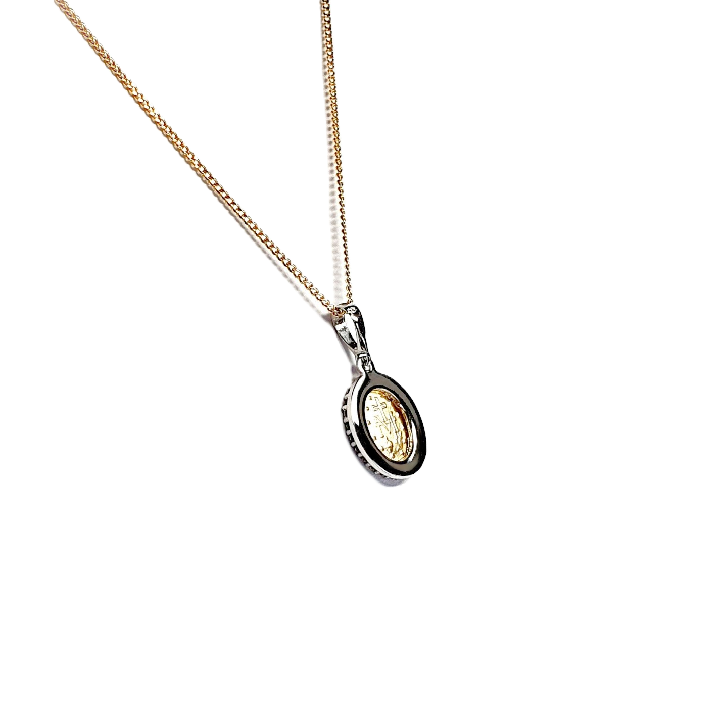 White & yellow gold oval Miraculous necklace surrounded with cubic zirconia, back view leaning left.