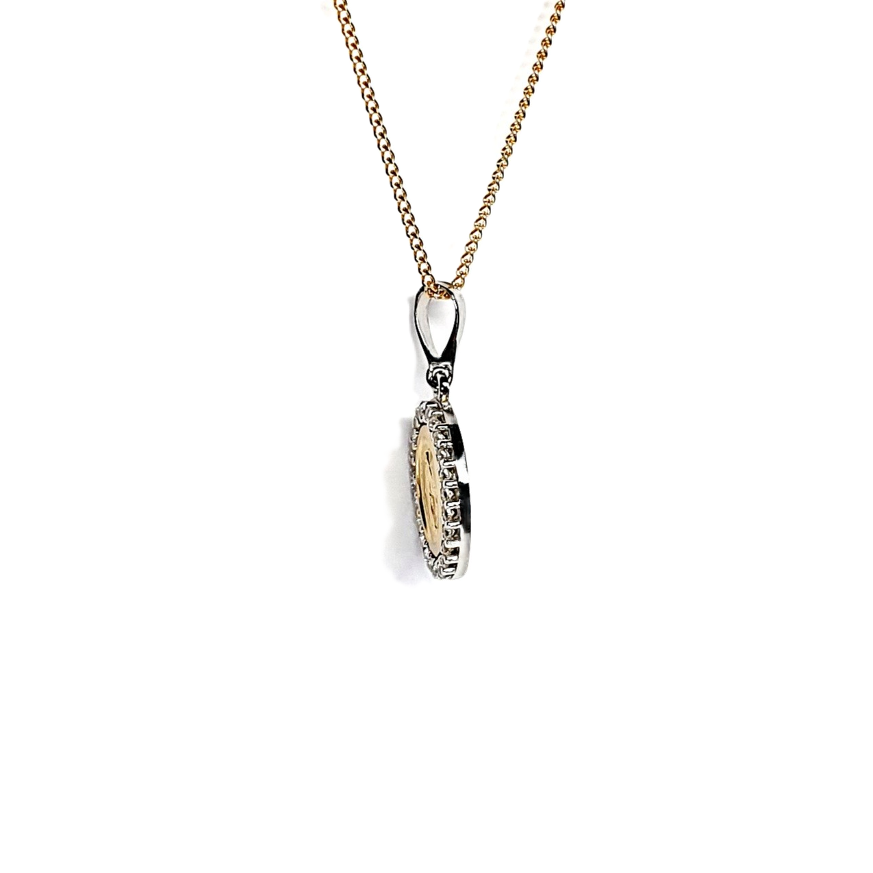 Two-tone 9ct gold Madonna pendant and chain surrounded with cubic zirconia, edge view.