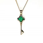 The same necklace shown from the front on a white backdrop, highlighting its fine gold detailing and natural malachite striping.
