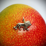 Leo the lion 3D 9ct gold charm pictured facing left on a mango.