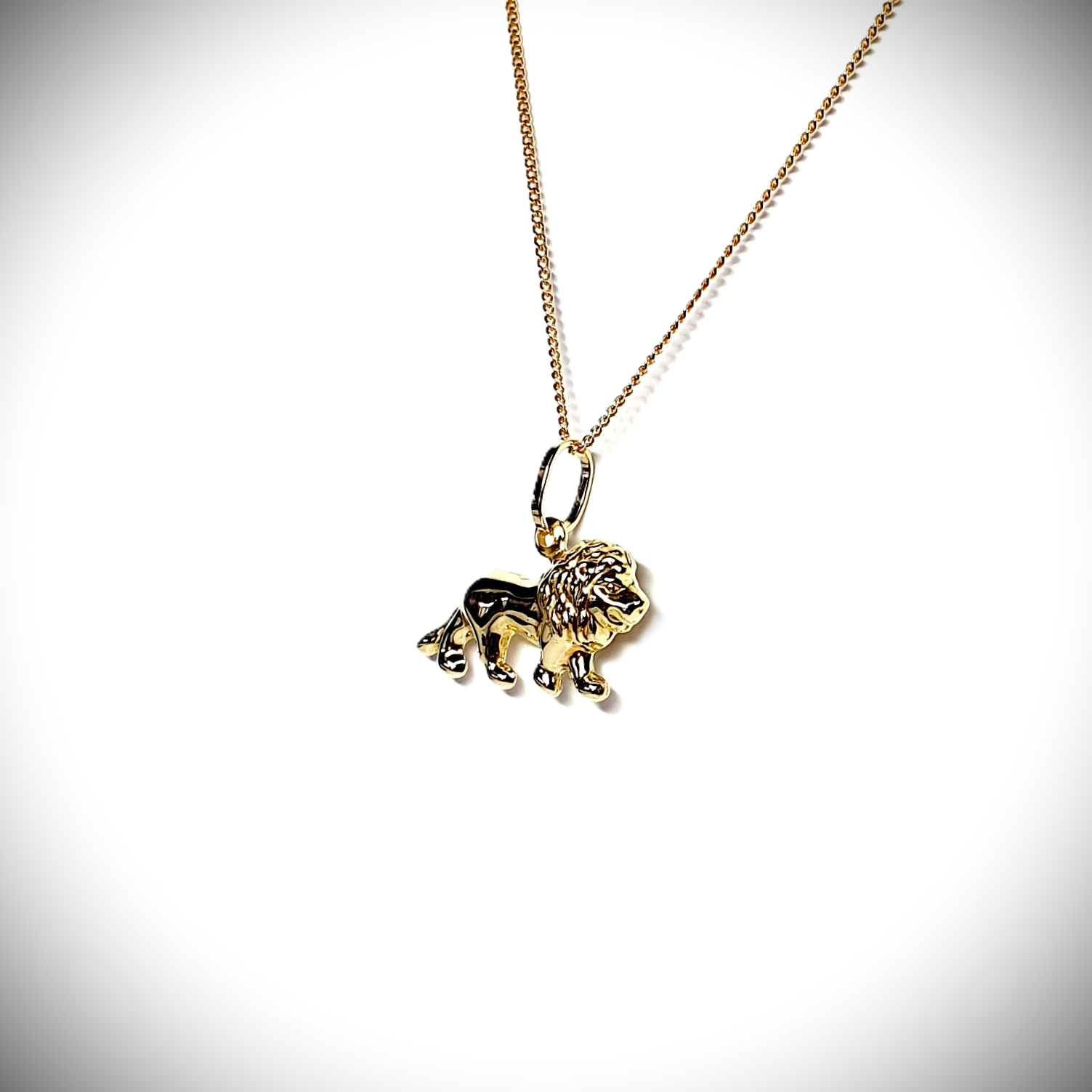 Close-up picture of a 3D lion necklace facing right, at a slight angle.