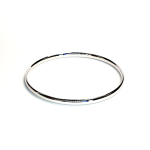 Comfort fit 4mm white gold stacking bangle laying on a flat surface.