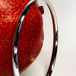 9ct white gold court shape bangle pictured with a mango.