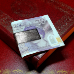 9-carat gold clip for your money with a barked pattern pictured with a £20.00 note.