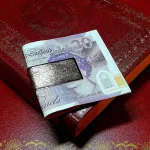 9-carat gold clip for your money with a barked pattern pictured with a £20.00 note.