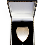 A solid gold money clip is pictured in the gift box.
