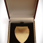 A solid gold money clip is pictured in the gift box.