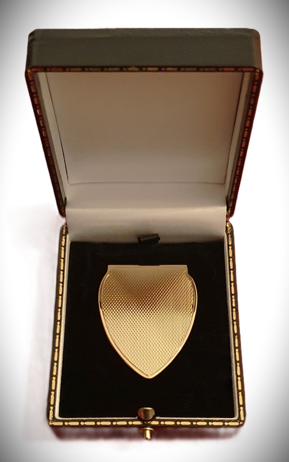 A solid gold money clip is pictured in the gift box.