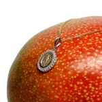 Hallmarked 9-carat yellow & white gold oval Miraculous necklace with a cubic zirconia border PC00556 is surrounded by a cubic zirconia border. The front view leans right to show at an angle pictured on a mango.