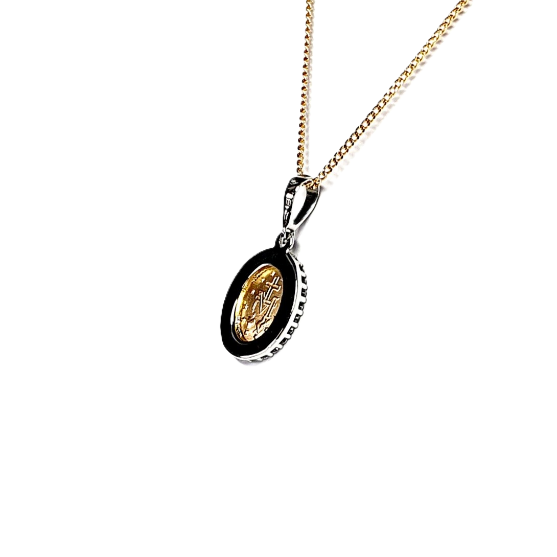 Two-tone 9ct gold Madonna pendant and chain surrounded with cubic zirconia, back view leaning right.