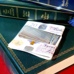 Washboard design, silver, two-sided cash clip pictured on green books with twenty pound notes.