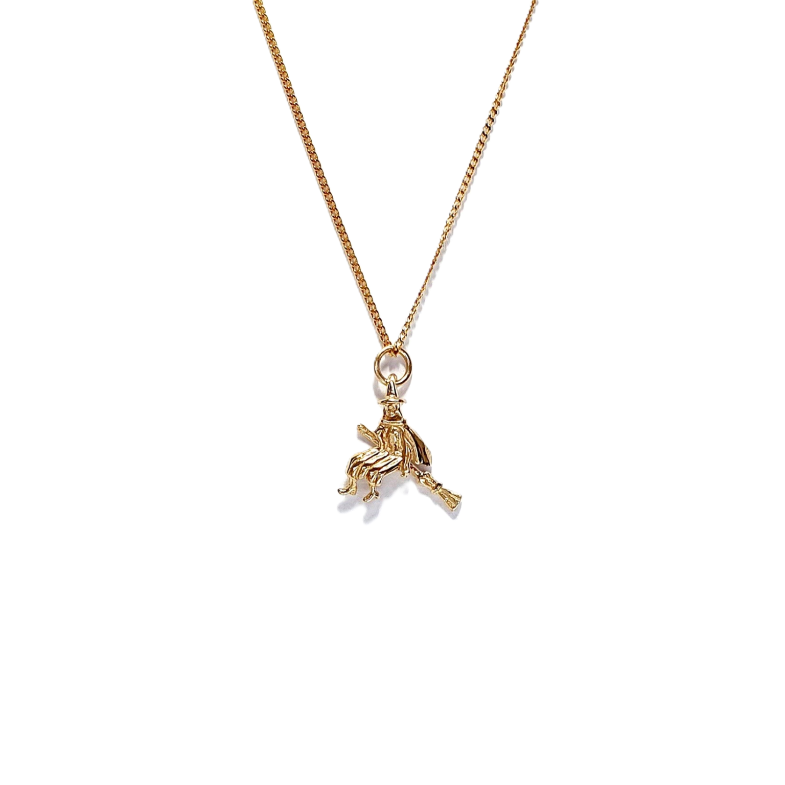 9ct yellow gold witch on her broomstick necklace with a close link curb chain.