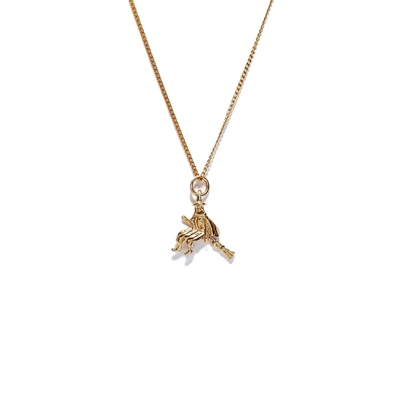 9ct yellow gold witch on her broomstick necklace with a close link curb chain.