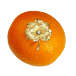 A textured yellow gold leaf brooch pin set with a single sparkling white diamond in the centre, pictured on an orange.