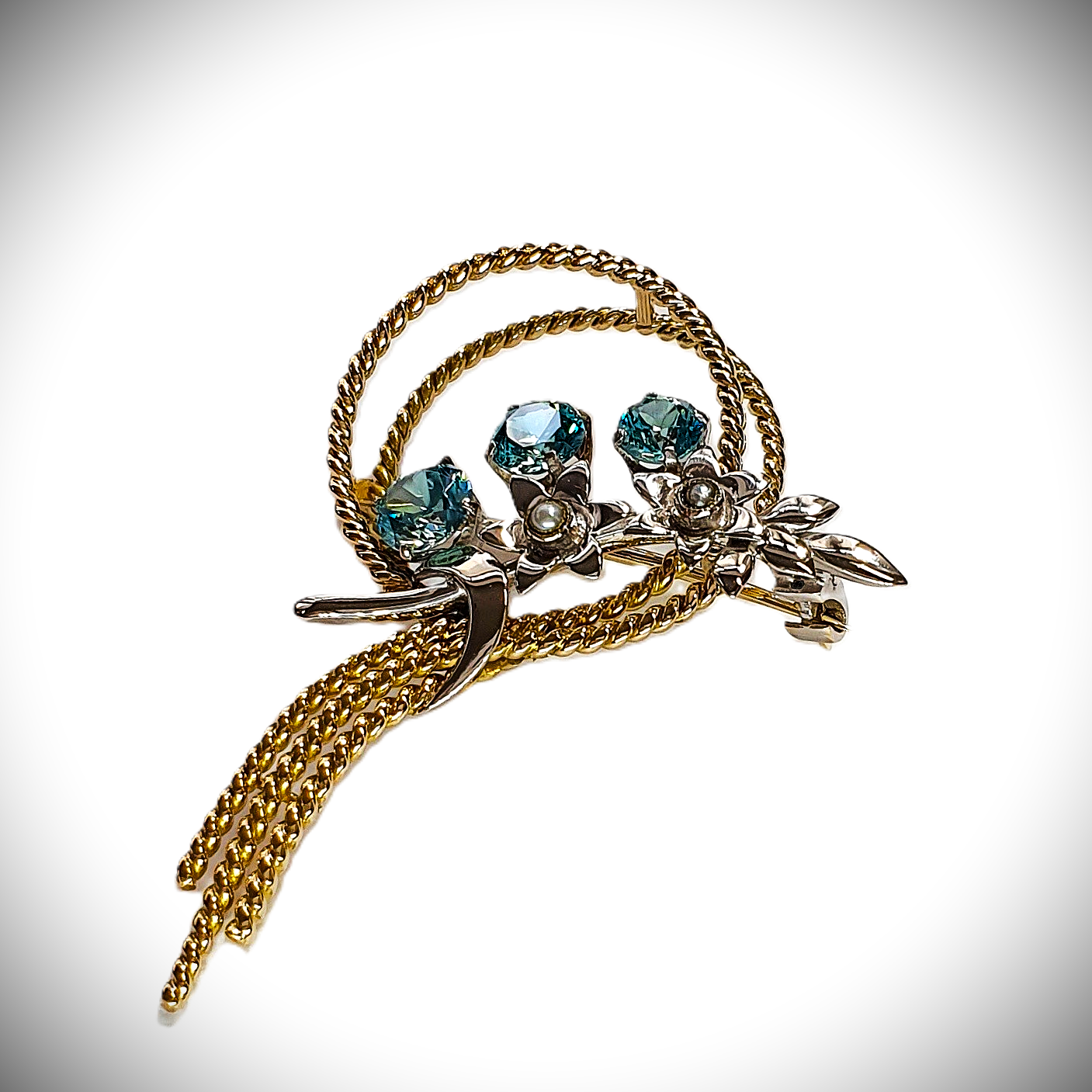 Handmade two tonne brooch with a bouquet-inspired twisted wire design. Pictured close up.