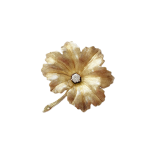 Textured yellow gold leaf brooch pin set with a single sparkling white diamond to the centre.