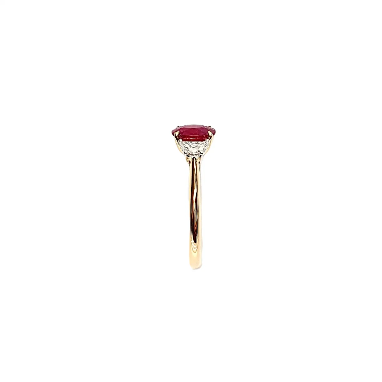 Detailed view of the ring's shoulders, highlighting the intricate design and craftsmanship supporting the gemstone settings.