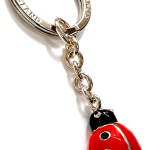 Close-up picture of a Ladybird in red and black vitreous enamel on a key fob made in real silver.