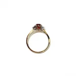 "Close-up of the structural side view of a ruby and diamond ring's settings."