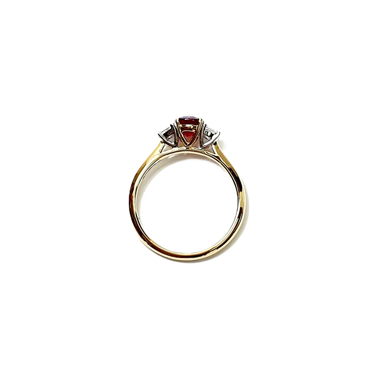 "Close-up of the structural side view of a ruby and diamond ring's settings."