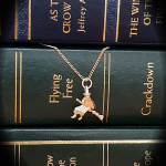 Picture of the witch landing on some giant books.