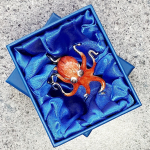 A gorgeous orange enamel Octopus made in Italy from genuine silver. Pictured in the gift box.