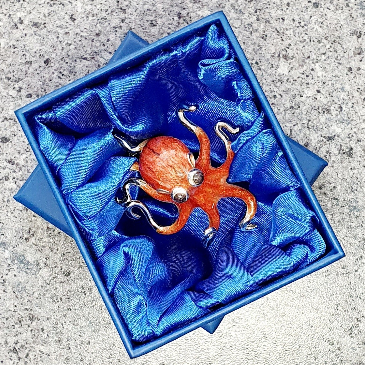 A gorgeous orange enamel Octopus made in Italy from genuine silver. Pictured in the gift box.