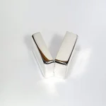 925 silver pill box laying sideways to showcase discreet hinge design and smooth edges in softly lit studio setting.