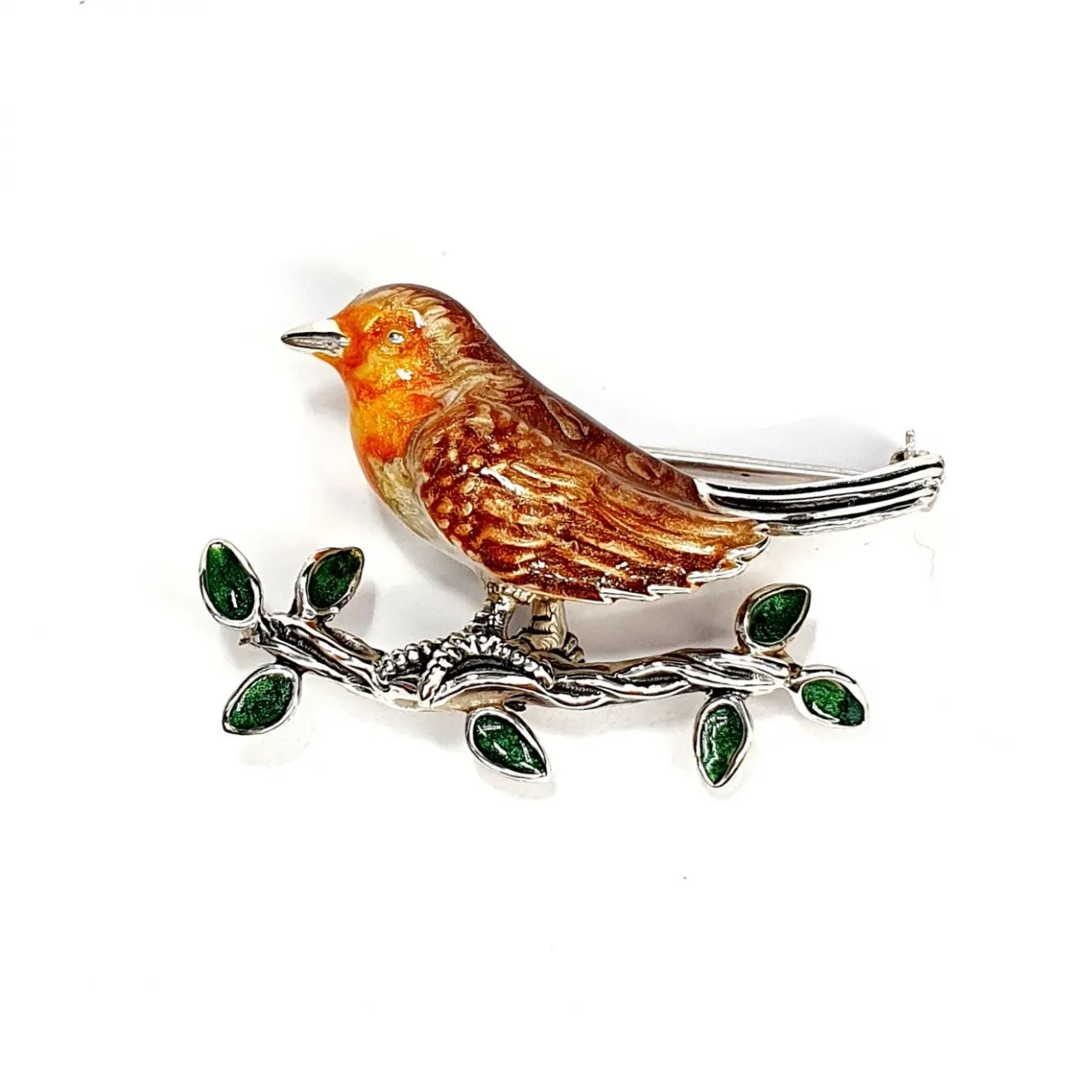Saturno silver enamelled robin red breast brooch sitting on a branch with enamelled green leaves.