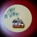 Elegant item displayed on bamboo-illustrated placemat with beige tones.