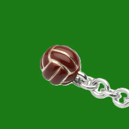 Statement Piece: Pictured against a rich green background, this football keyring evokes the spirit of the game, contrasting beautifully with its vintage brown enamel finish.